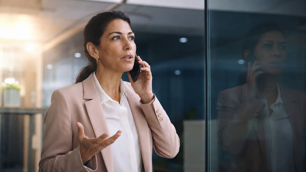 Two leaders discussing a plan at a wall